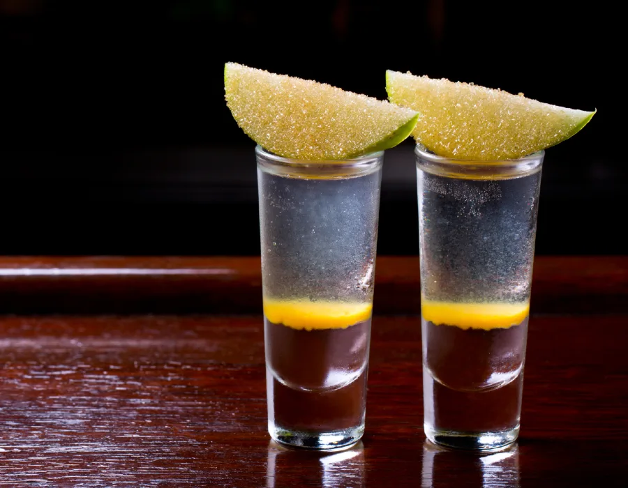 lemon drop layered shooter with sugar coated lemon wedge