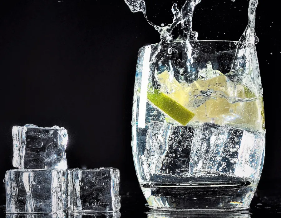 pour gin in glass for classic cocktail recipe