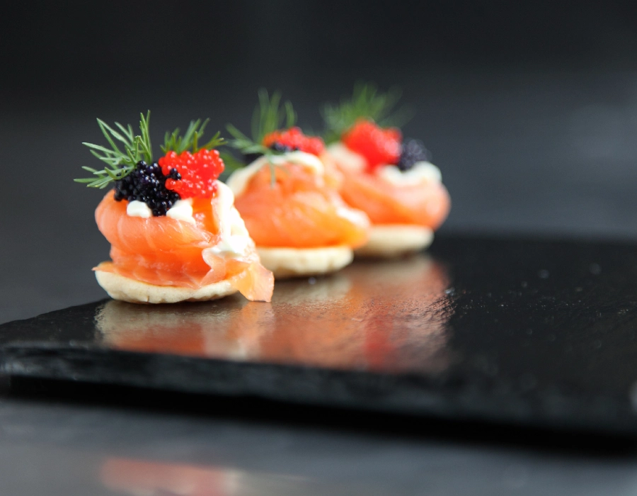 canapes on a black serving plate