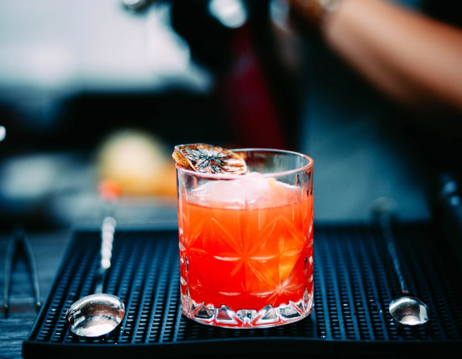 balanced gin drink with burnt lemon peel as garnish