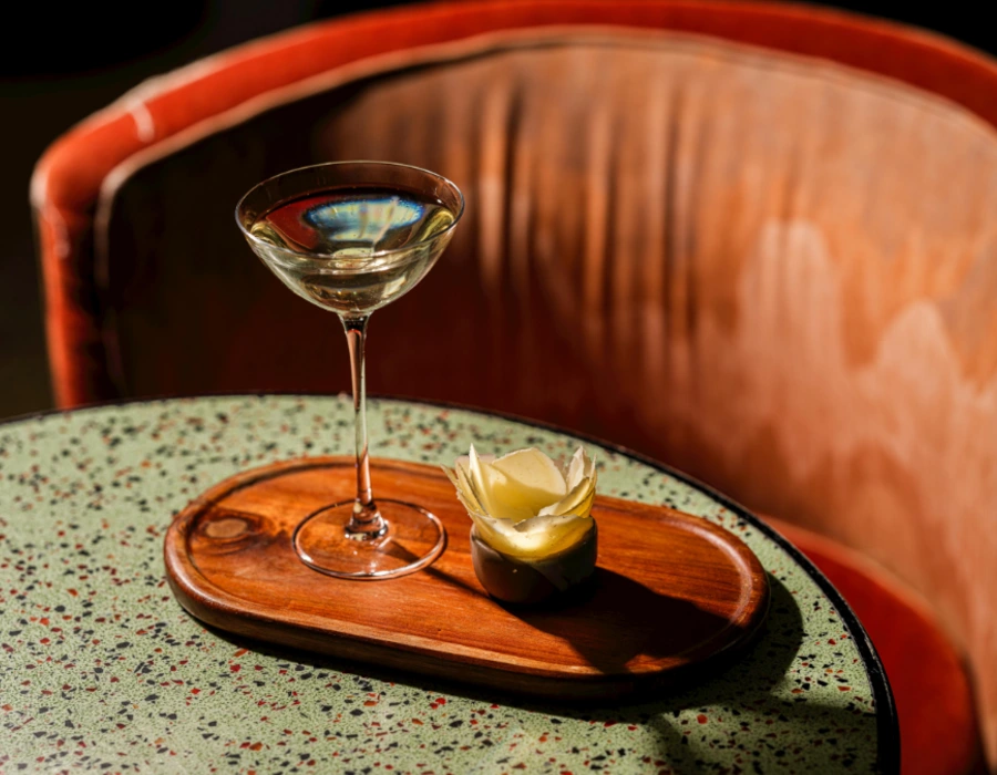 gin cocktail with flower next to it