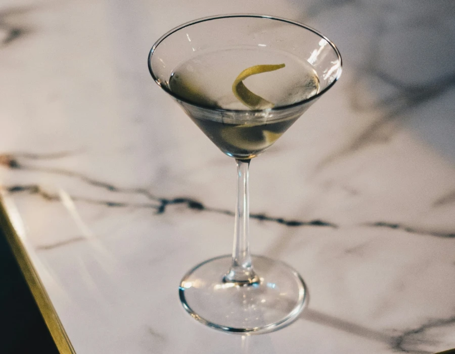 martini with a twist on the edge of table