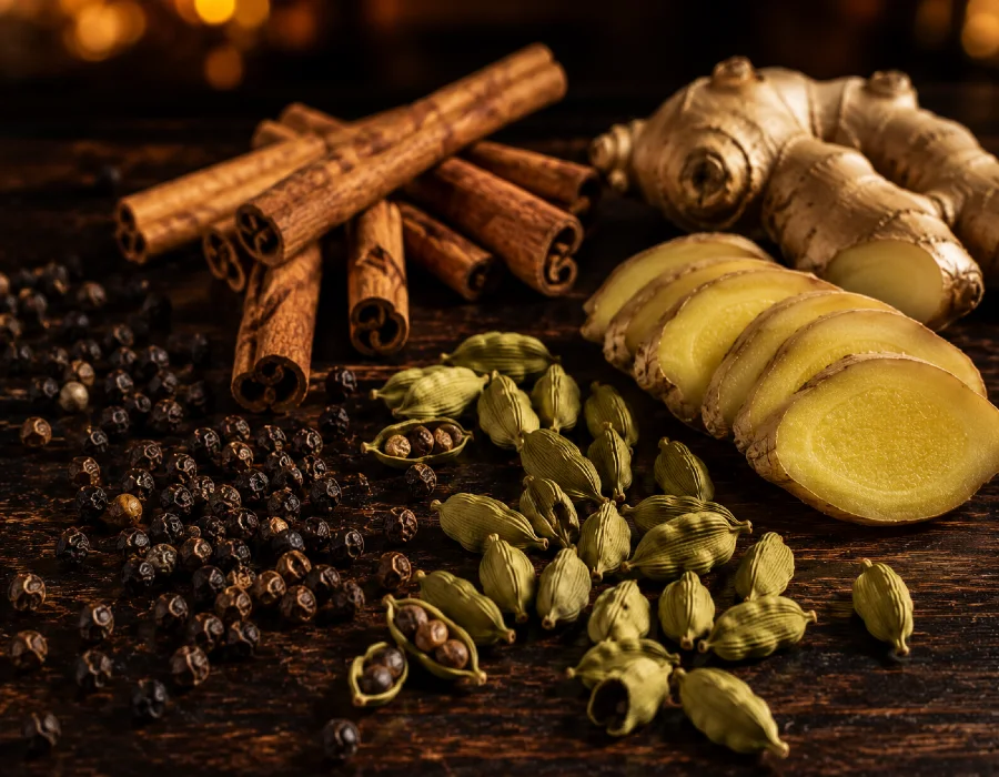 black pepper, cardamom, ginger and cinnamon on table