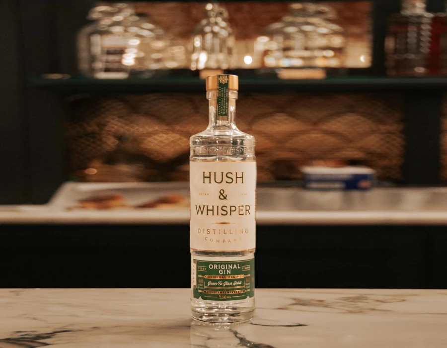 bottle of hush and whisper on bar counter