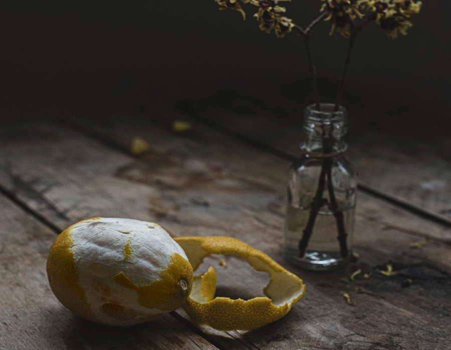 lemon that is semi-peeled on wooden countertop