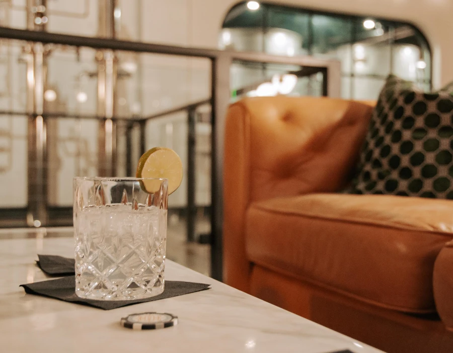 tumbler with lemon garnish on marble table