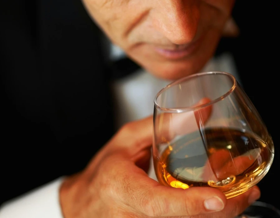man smelling whiskey