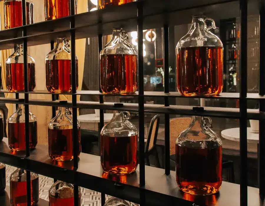 whiskey displayed in vintage-style glass bottles with small loop handles